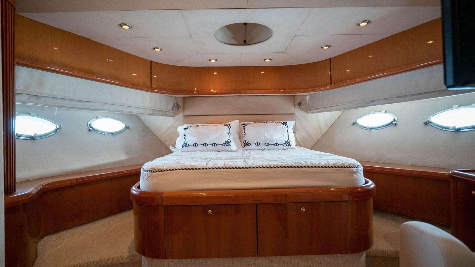 a room with a bed and a mirror aboard LUCKY BEAR Yacht for Sale
