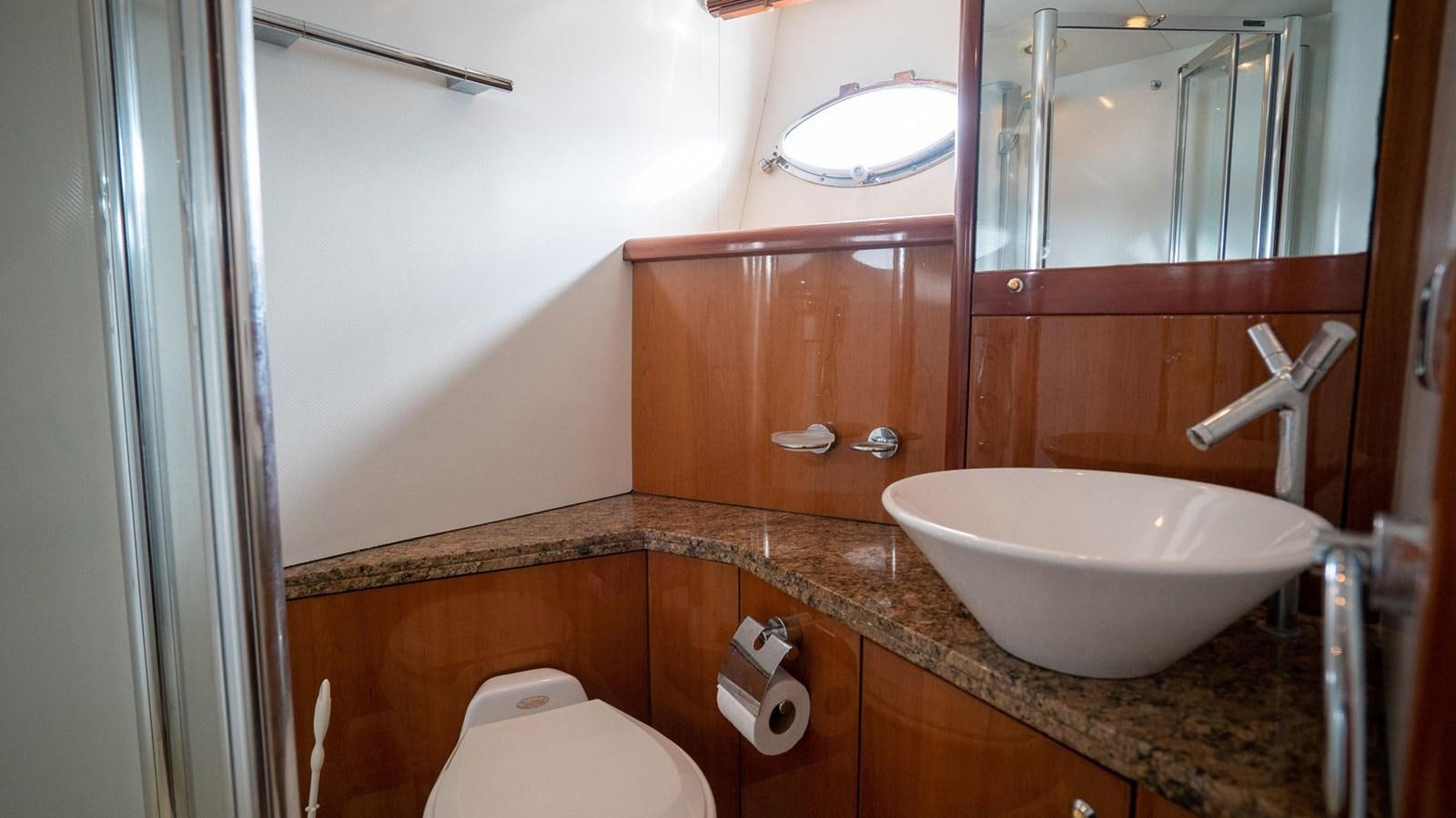 a bathroom with a sink and a toilet aboard LUCKY BEAR Yacht for Sale
