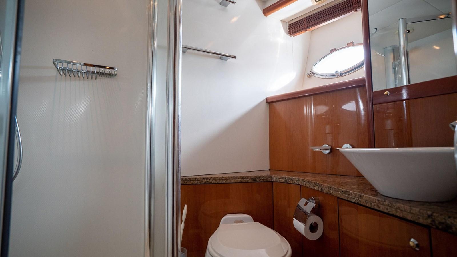a bathroom with a sink and toilet aboard LUCKY BEAR Yacht for Sale