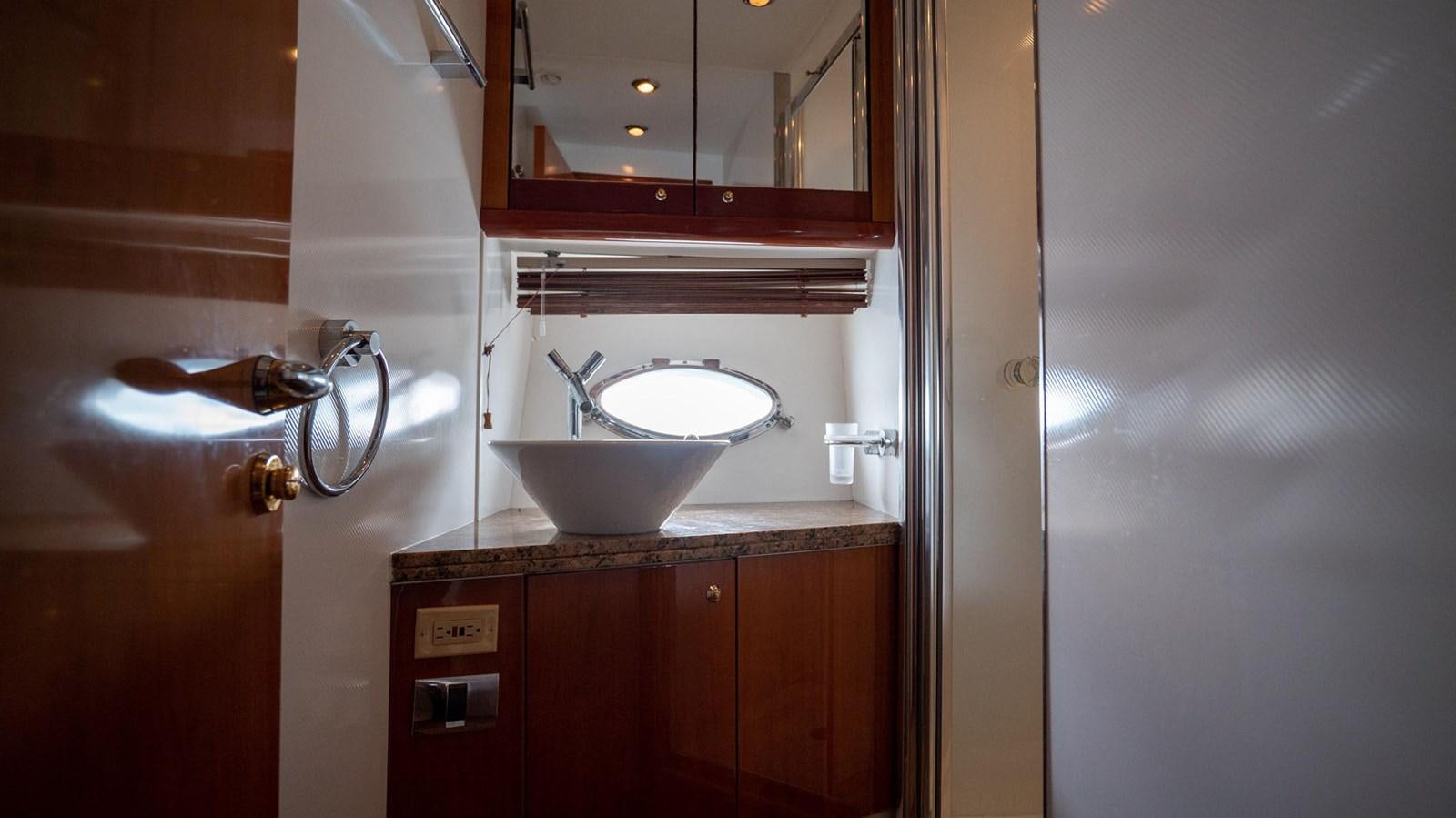 a sink and a mirror in a bathroom aboard LUCKY BEAR Yacht for Sale
