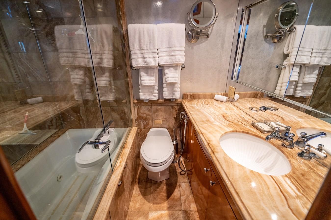 a bathroom with a sink toilet and bathtub aboard DIAMOND LADY Yacht for Sale