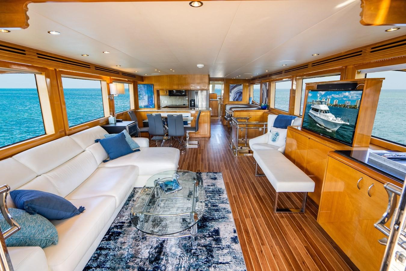 a living room with a large screen aboard DIAMOND LADY Yacht for Sale