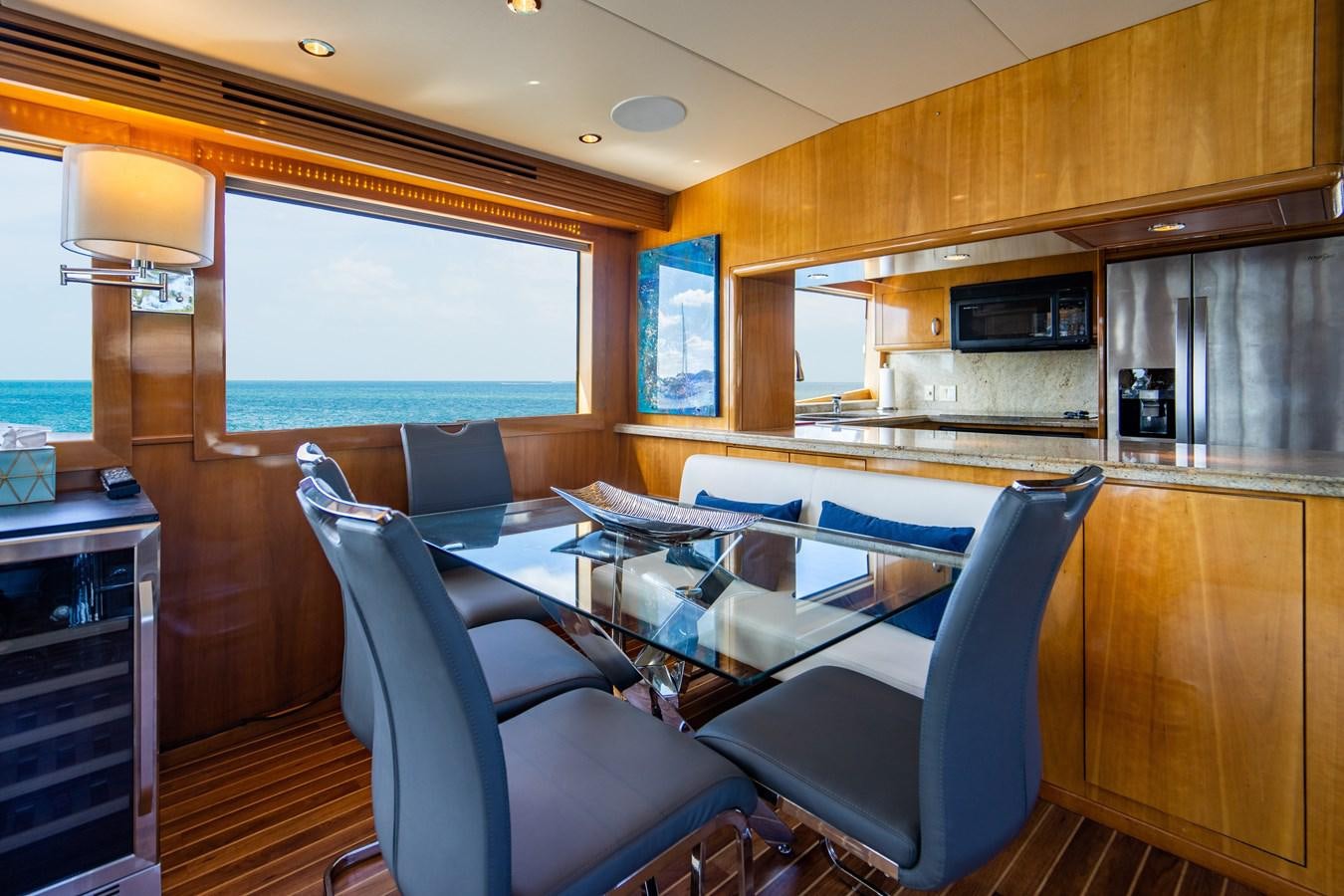 a room with a table chairs and a window aboard DIAMOND LADY Yacht for Sale