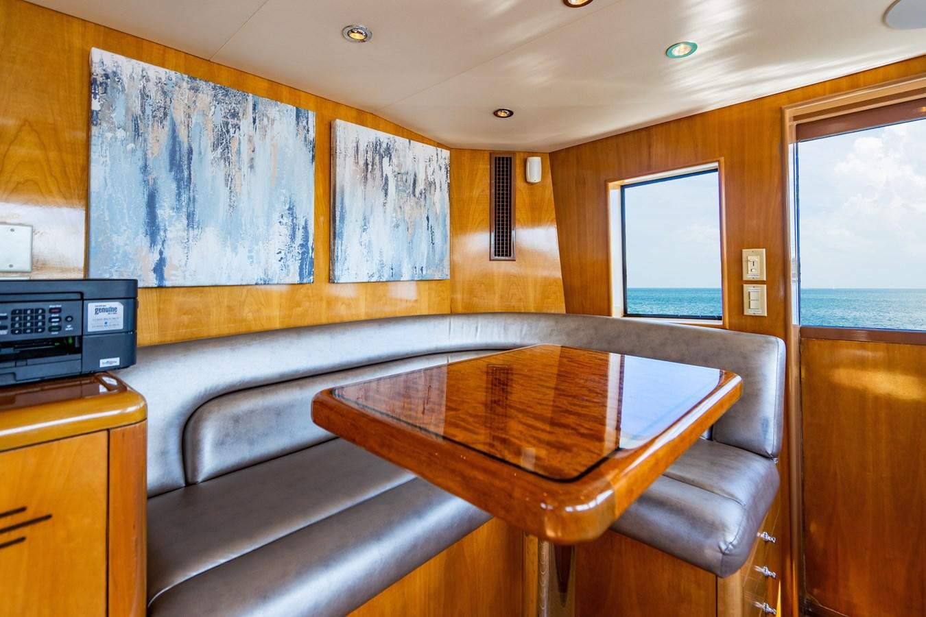 a room with a table and chairs aboard DIAMOND LADY Yacht for Sale