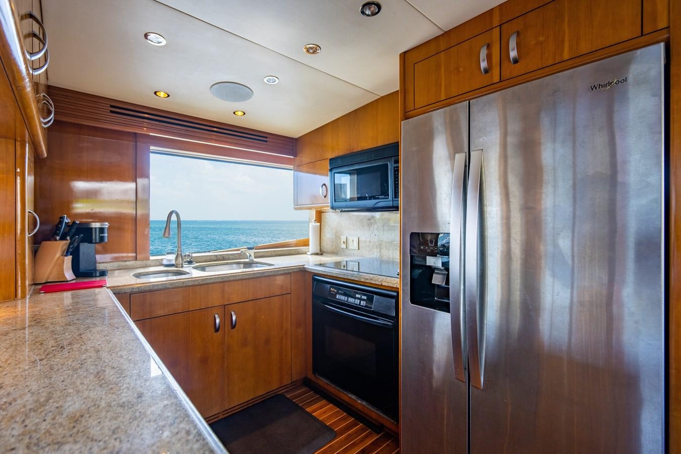 a kitchen with a stainless steel refrigerator aboard DIAMOND LADY Yacht for Sale