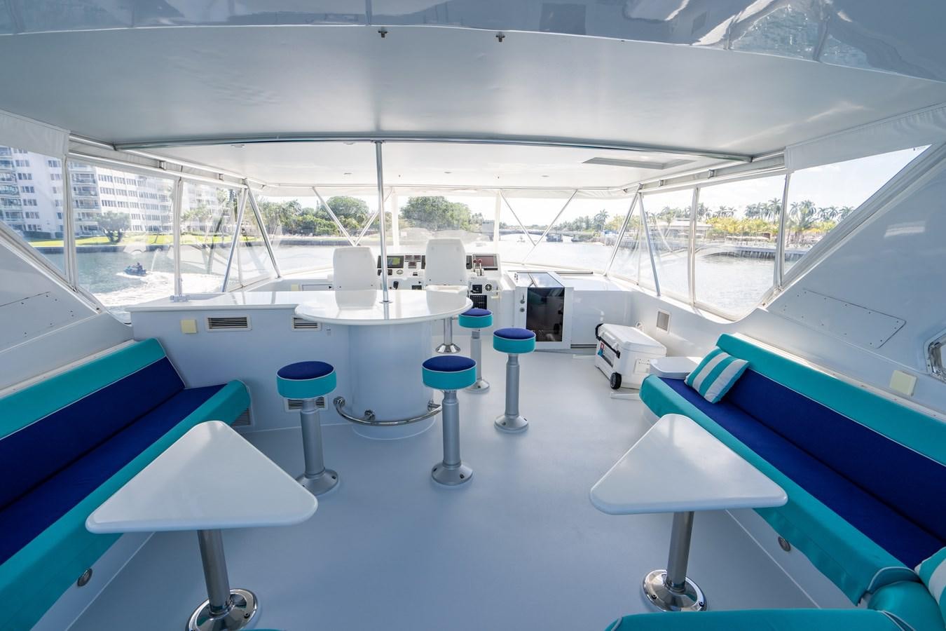 a room with tables and chairs aboard DIAMOND LADY Yacht for Sale