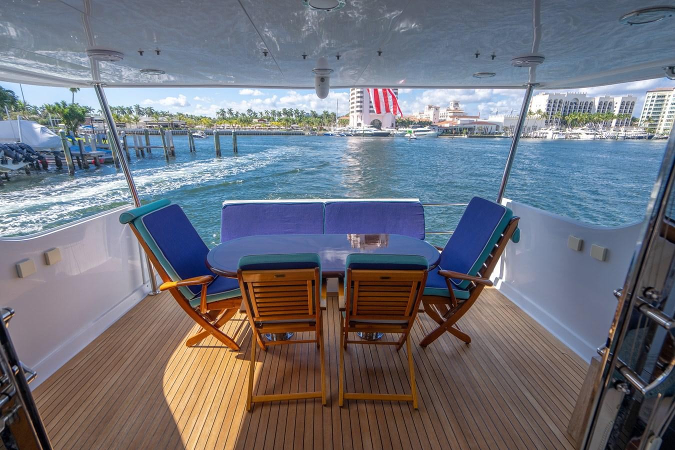 a deck with a table and chairs on it aboard DIAMOND LADY Yacht for Sale