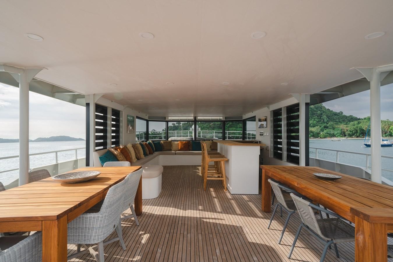 a large room with a table and chairs aboard SOUTHERN CROSS Yacht for Charter