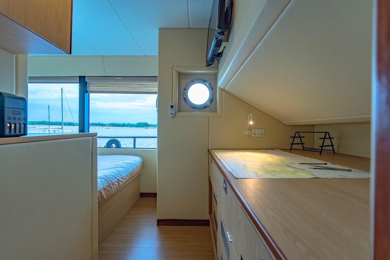 a room with a bed and a large window aboard SOUTHERN CROSS Yacht for Charter