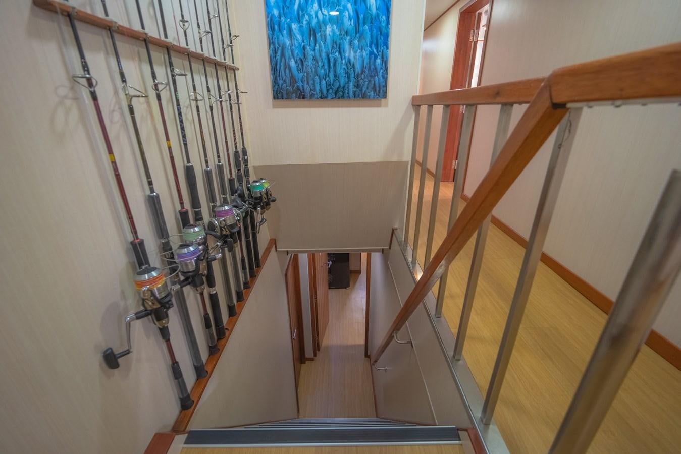 a staircase with a painting on the wall aboard SOUTHERN CROSS Yacht for Charter