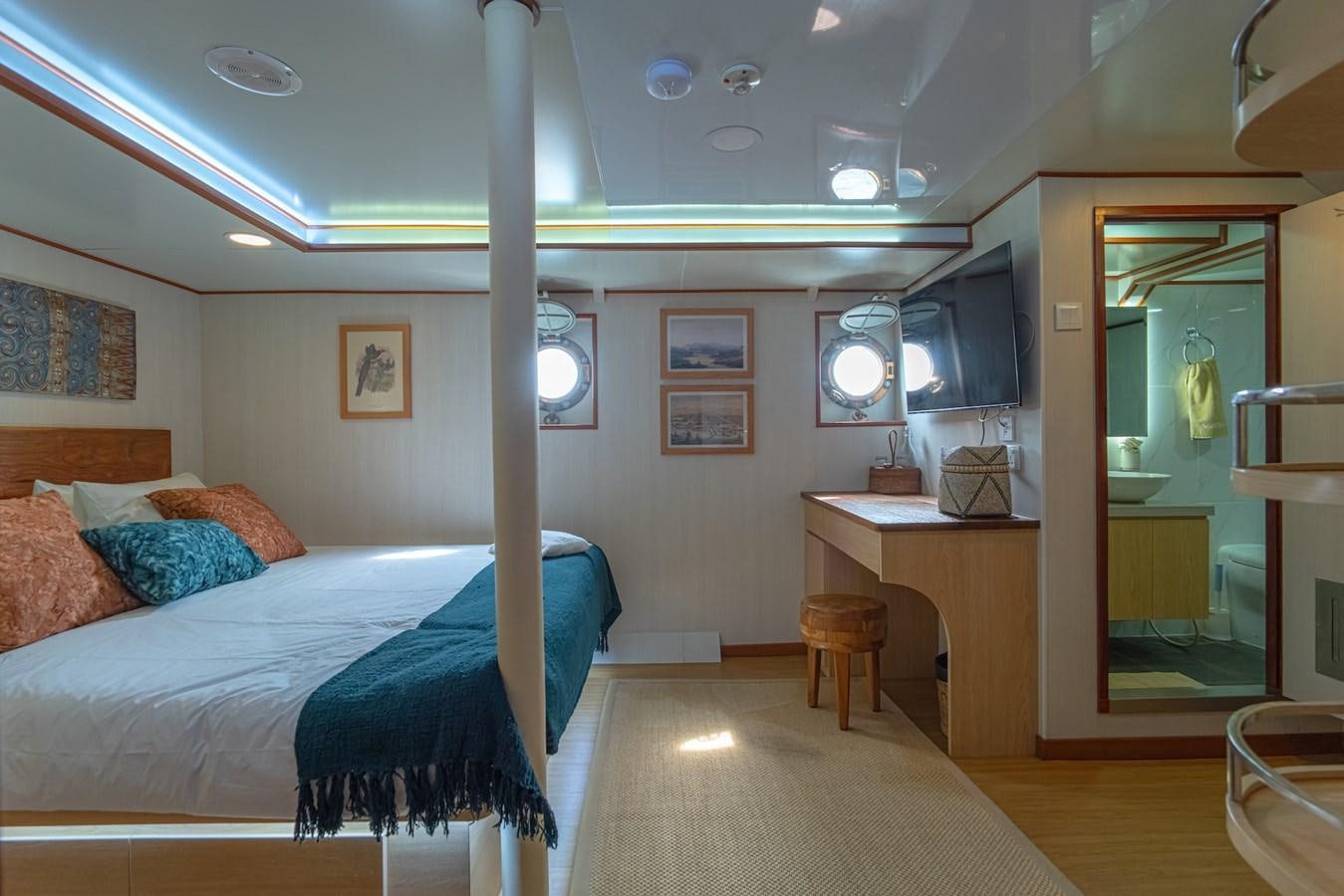 a bedroom with a bed and a desk aboard SOUTHERN CROSS Yacht for Charter