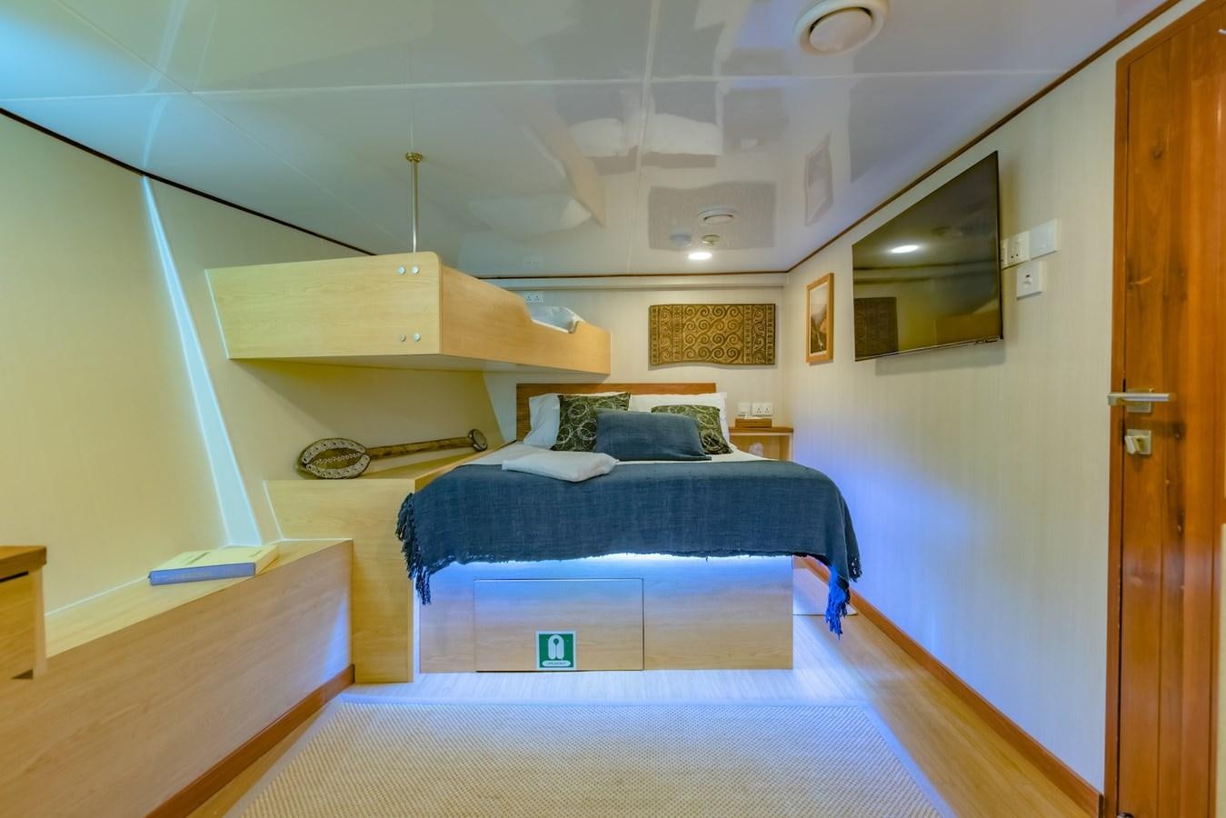 a bedroom with a bed and a desk aboard SOUTHERN CROSS Yacht for Charter
