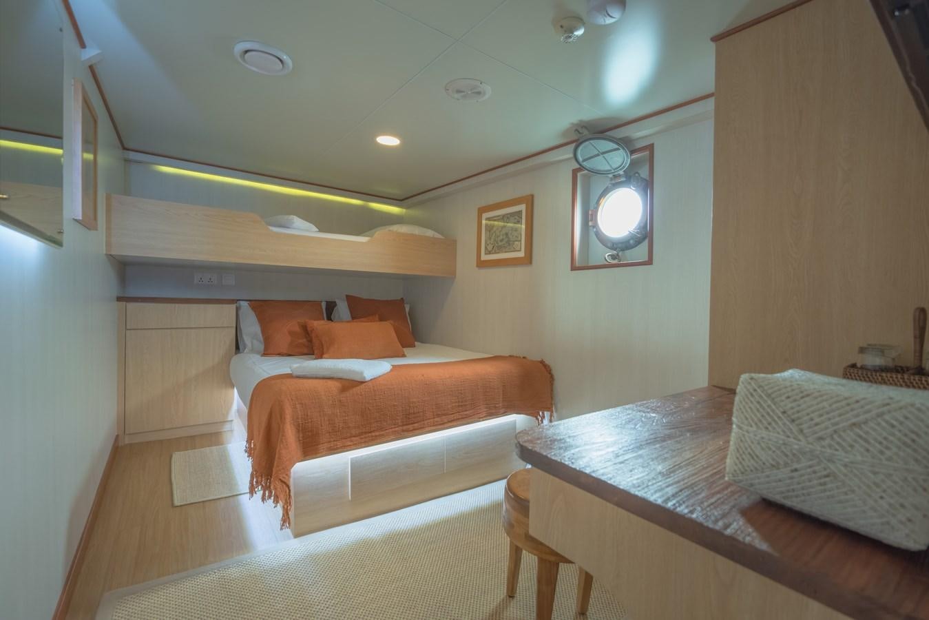 a room with a bed and a table aboard SOUTHERN CROSS Yacht for Charter