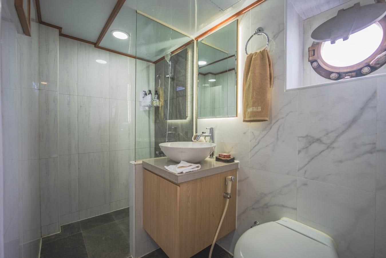 a bathroom with a sink and a mirror aboard SOUTHERN CROSS Yacht for Charter