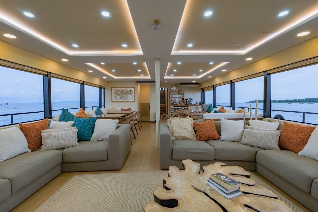 a living room with a couch and a large window aboard SOUTHERN CROSS Yacht for Charter