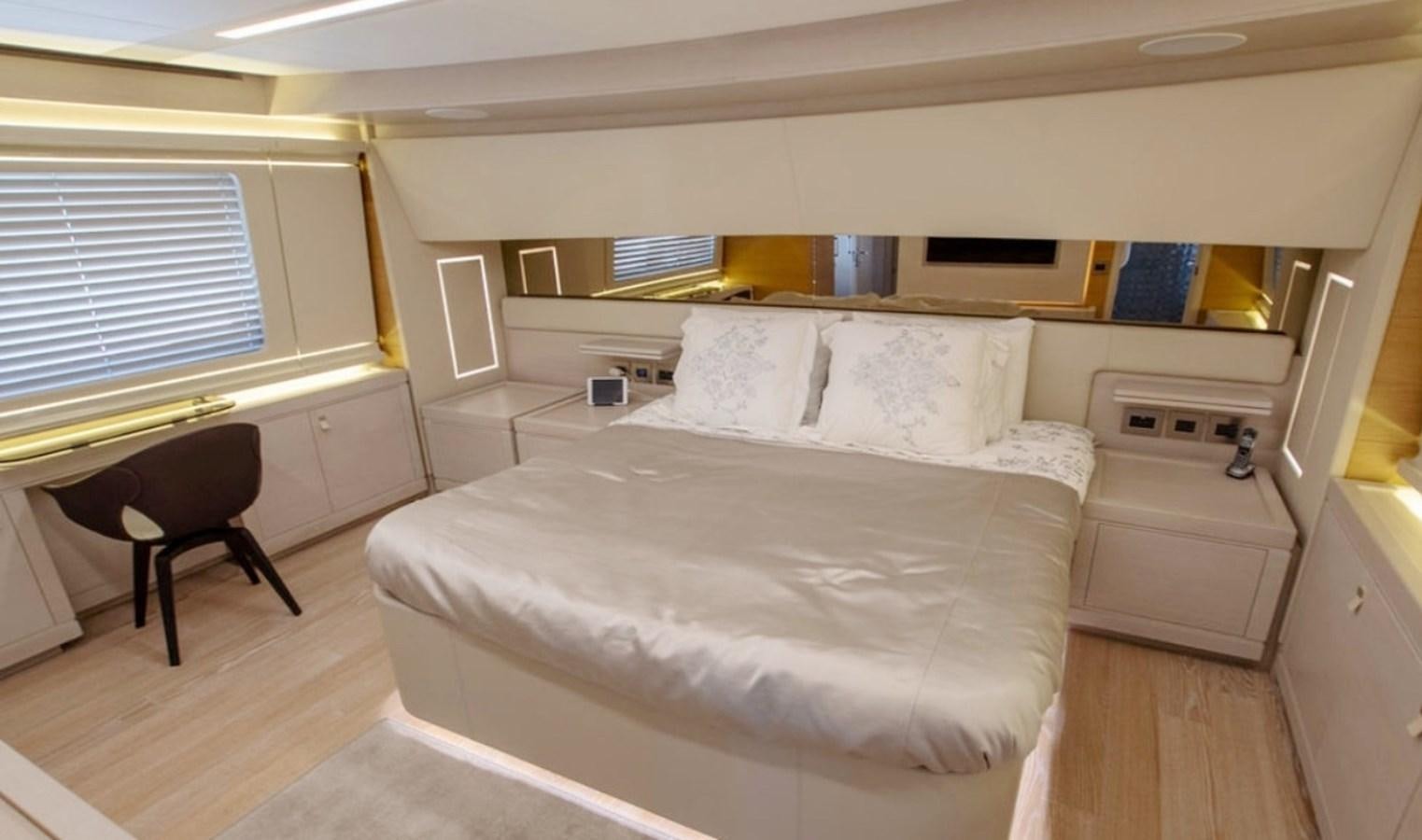 a bedroom with a bed and a chair aboard D'VINCI Yacht for Sale