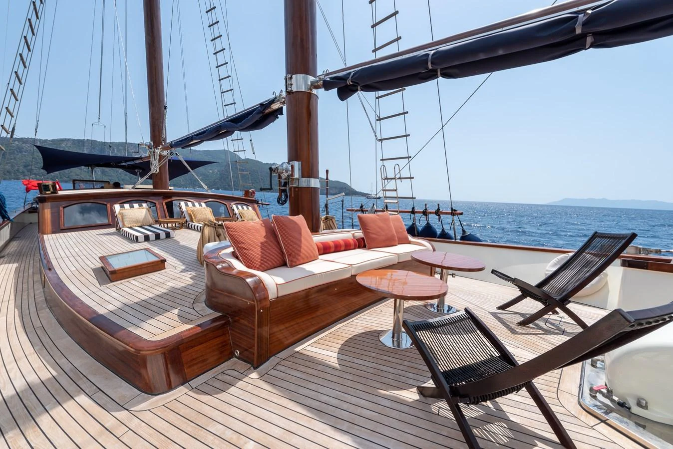 a deck with a couch and chairs on it aboard CAPTAIN COOK Yacht for Sale