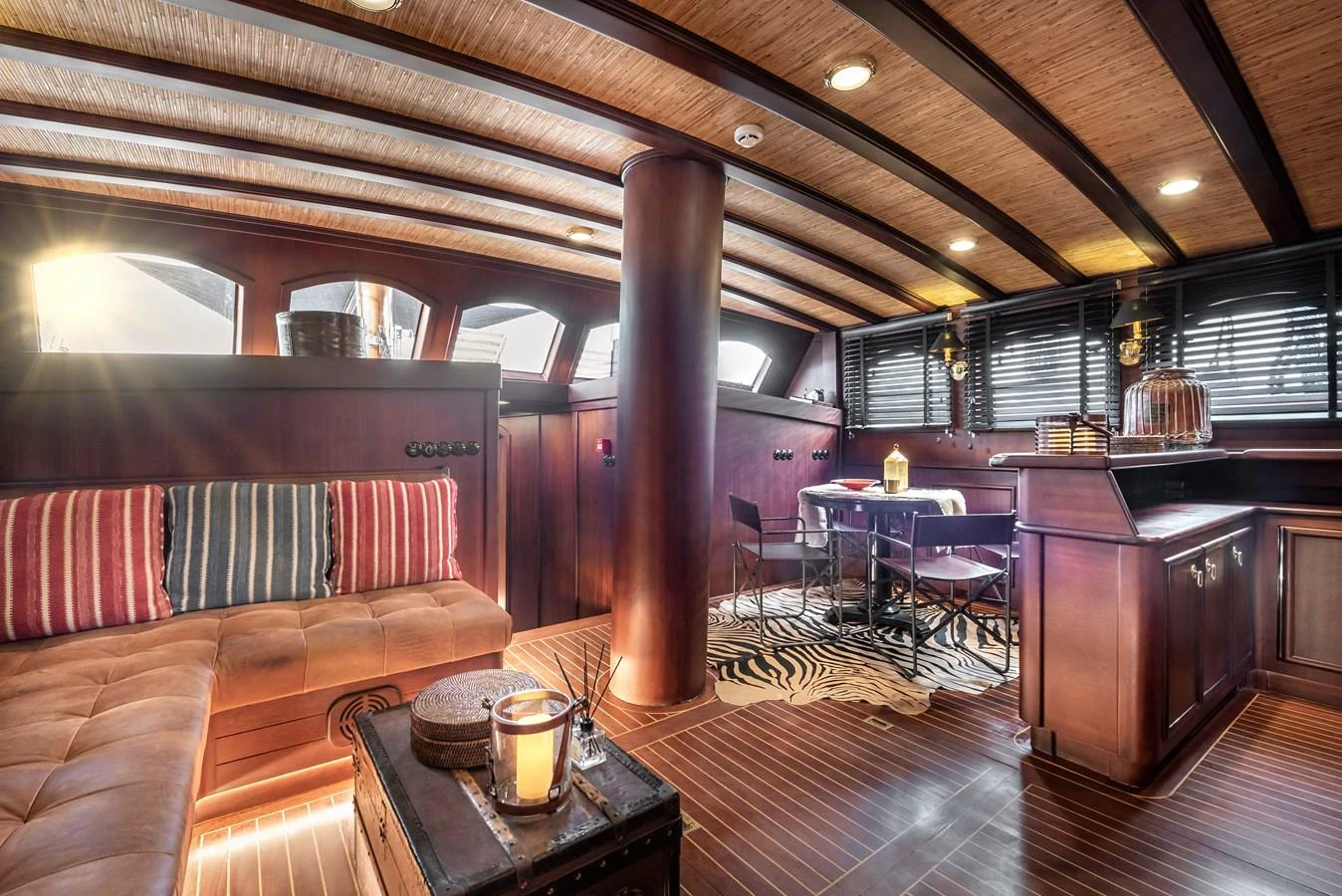 a room with a wood floor and a wood table and chairs aboard CAPTAIN COOK Yacht for Sale