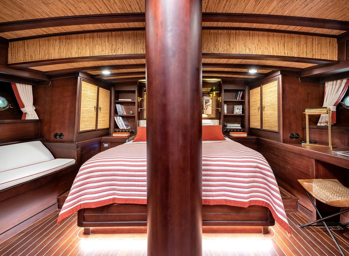 a room with a bed and a table aboard CAPTAIN COOK Yacht for Sale