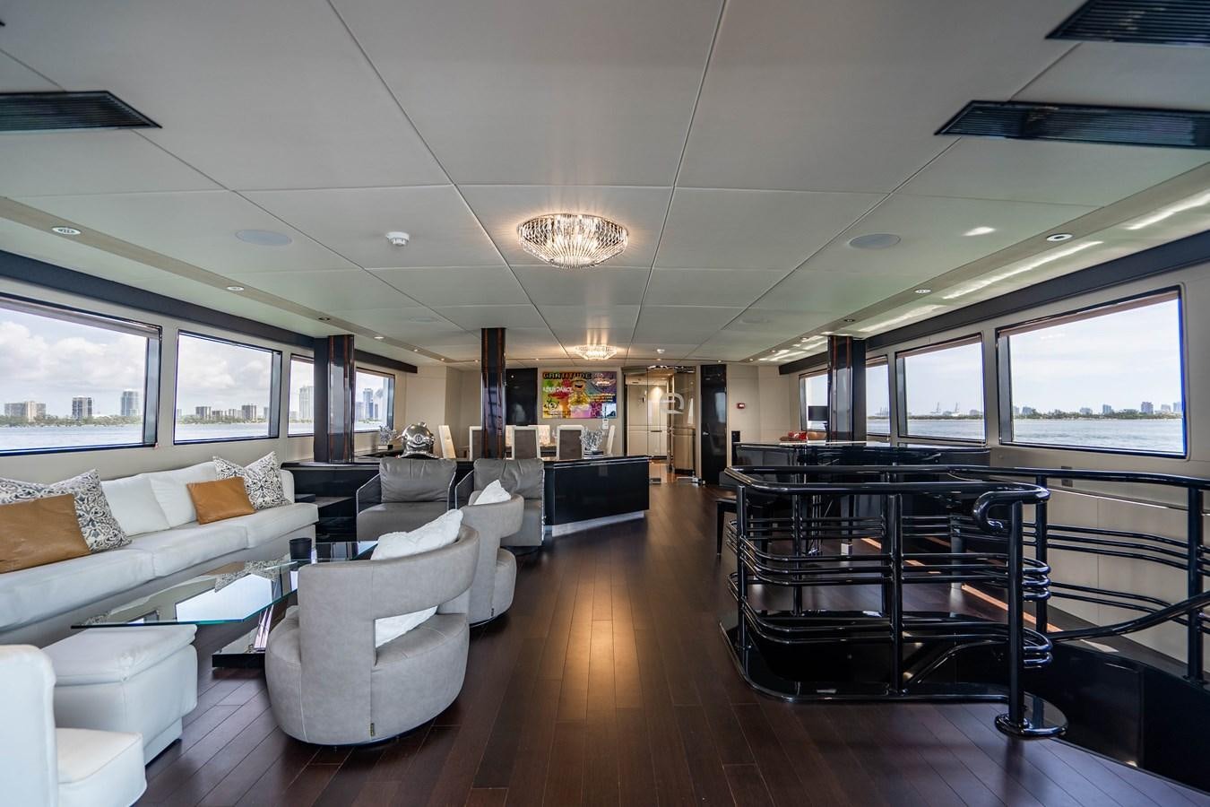 a living room with a large table and chairs aboard QUANTUM Yacht for Sale