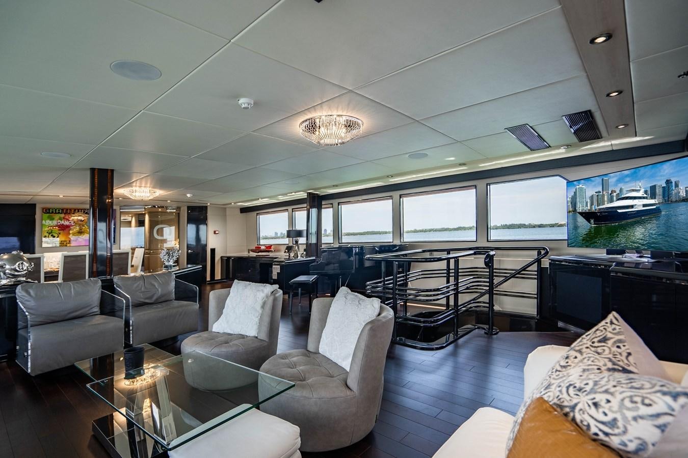 a living room with a large screen aboard QUANTUM Yacht for Sale