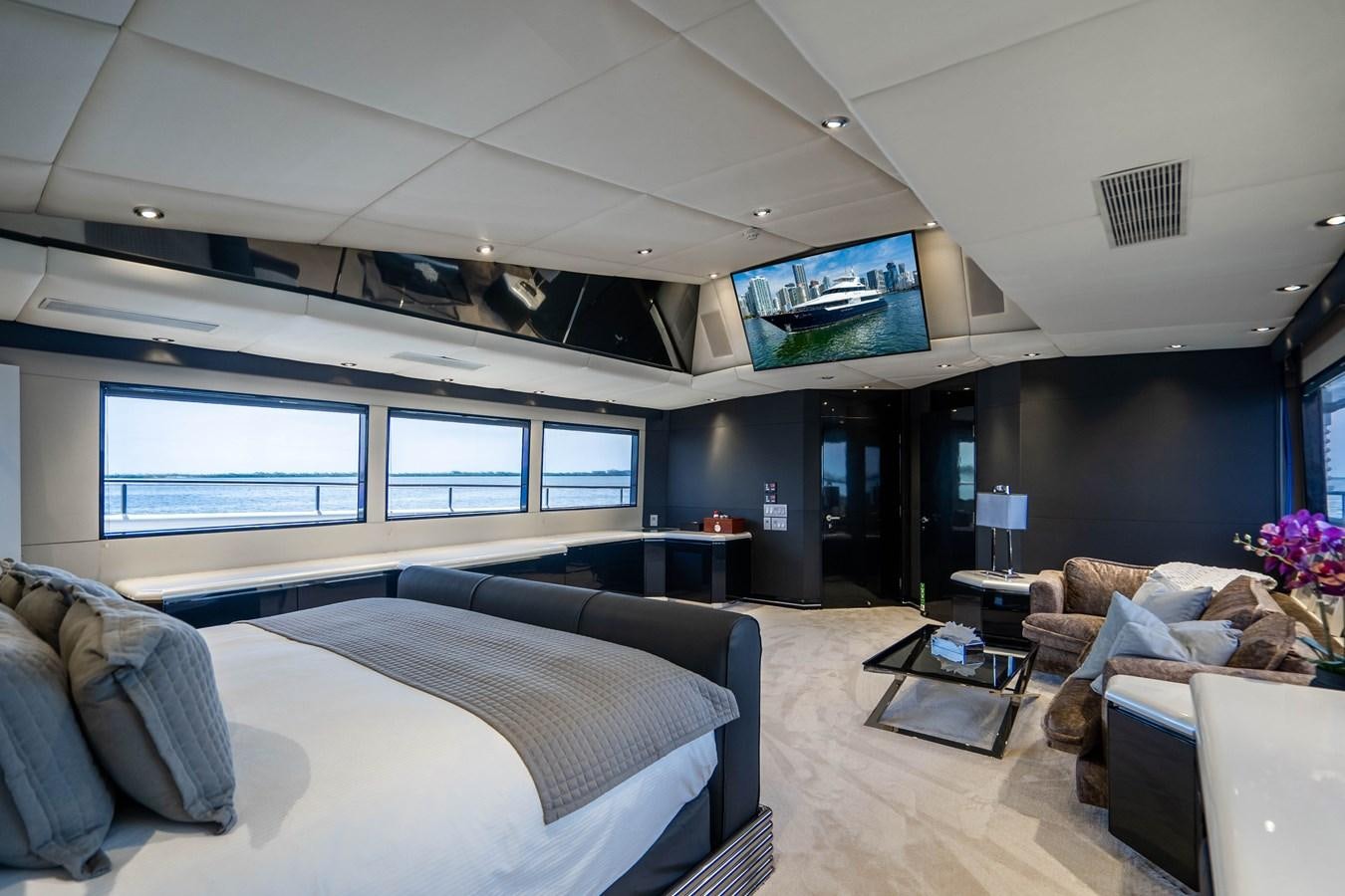 a room with a bed and a couch aboard QUANTUM Yacht for Sale