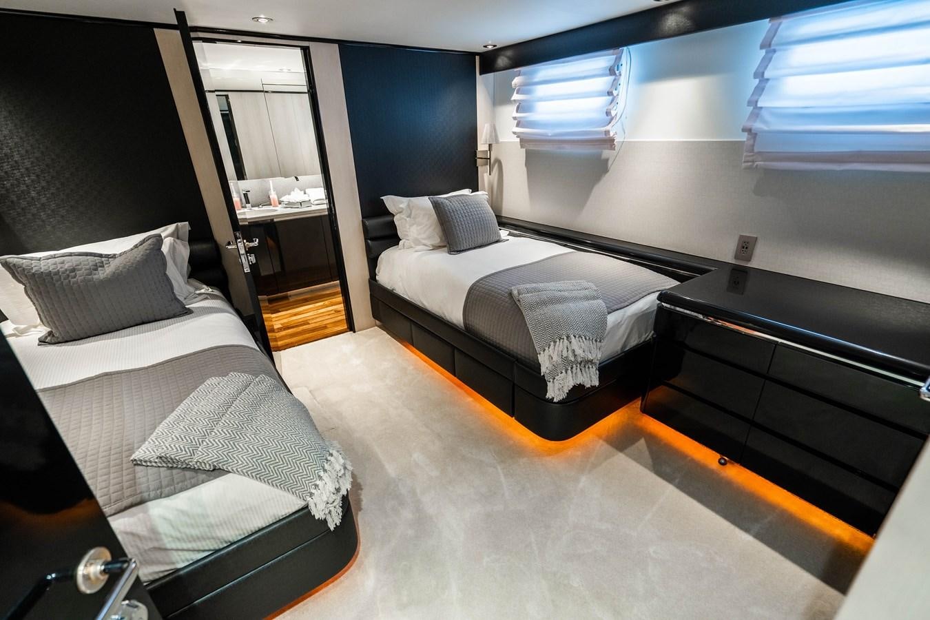 a room with a bed and a desk aboard QUANTUM Yacht for Sale