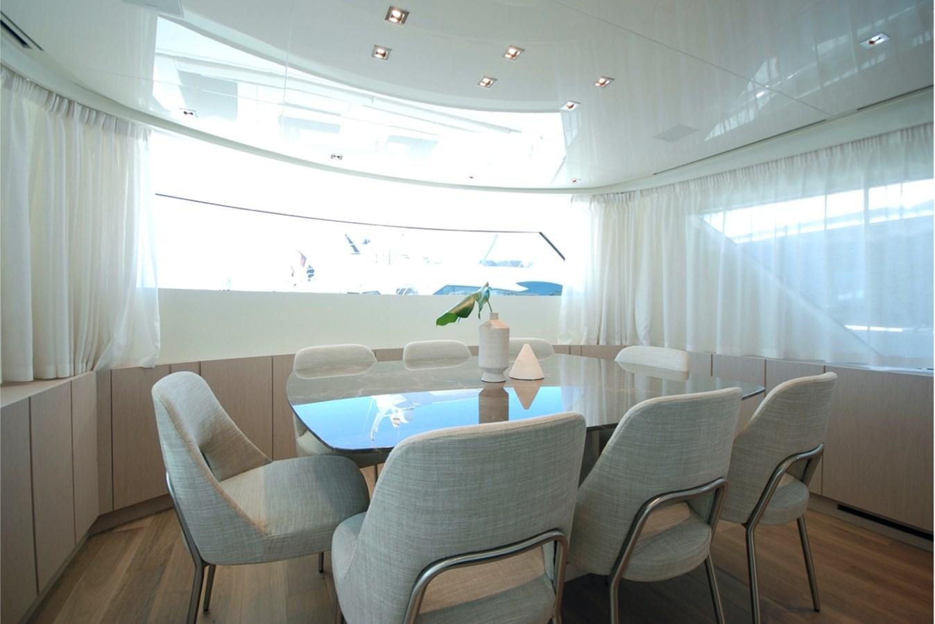 a room with a table and chairs aboard SANLORENZO SX76 Yacht for Sale