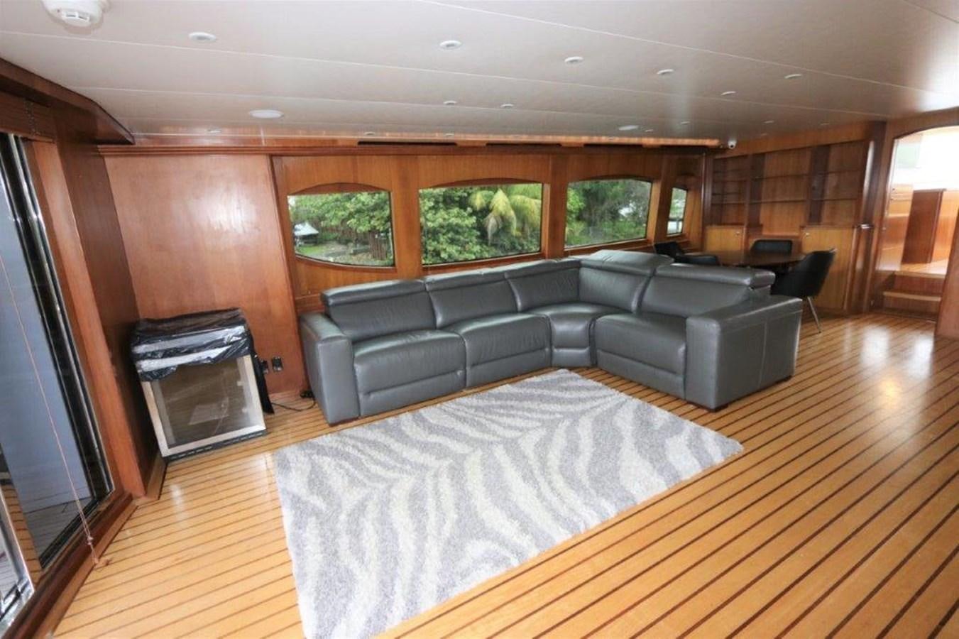 a living room with leather couches and a fireplace aboard HATGS618A606 Yacht for Sale