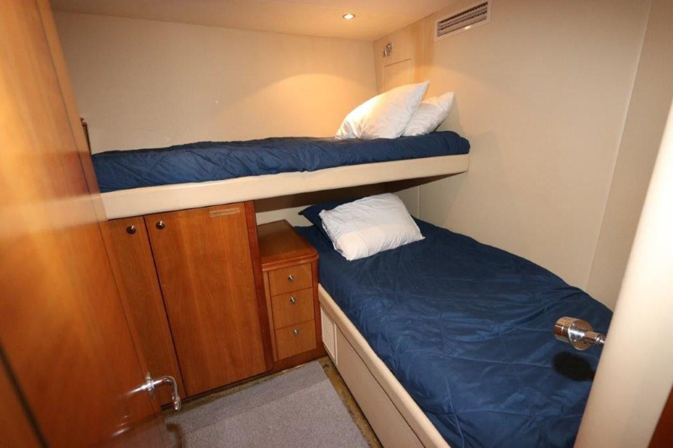 a bed with a blue sheet aboard HATGS618A606 Yacht for Sale