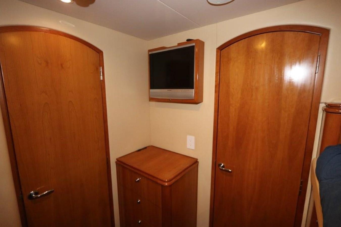 a room with a wood cabinet and television aboard HATGS618A606 Yacht for Sale