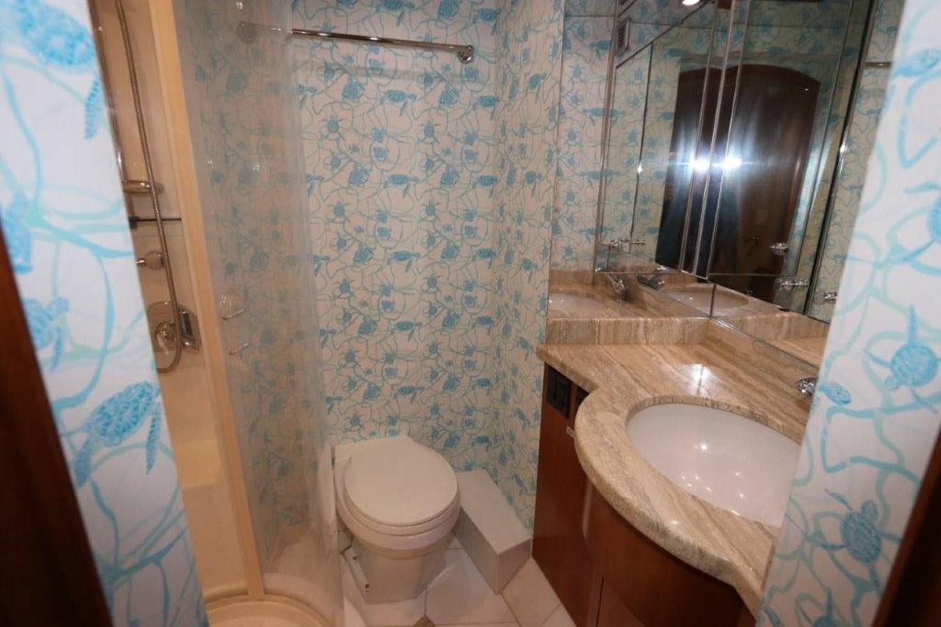 a bathroom with a sink toilet and a mirror aboard HATGS618A606 Yacht for Sale