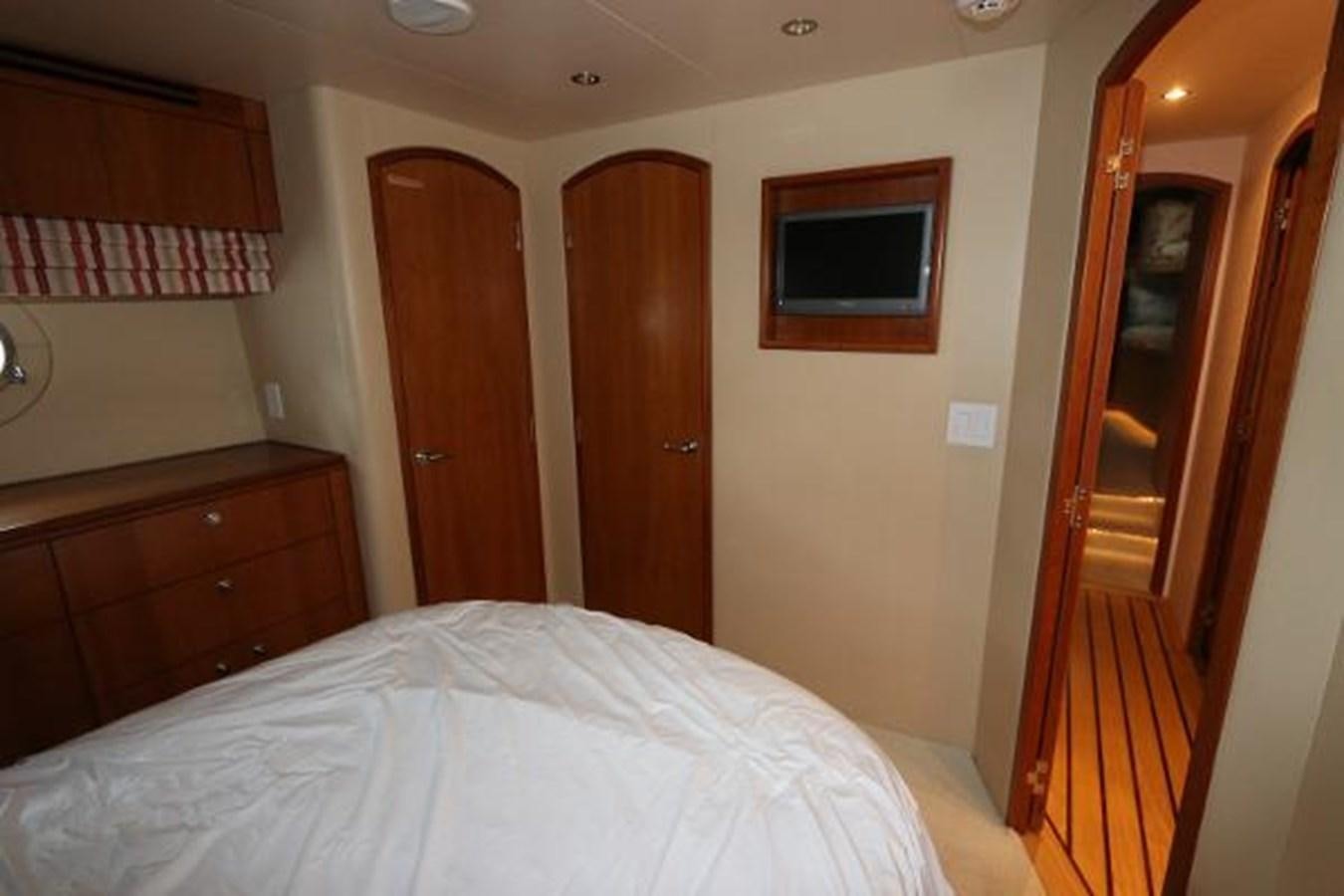 a bedroom with a bed and a wood door aboard HATGS618A606 Yacht for Sale