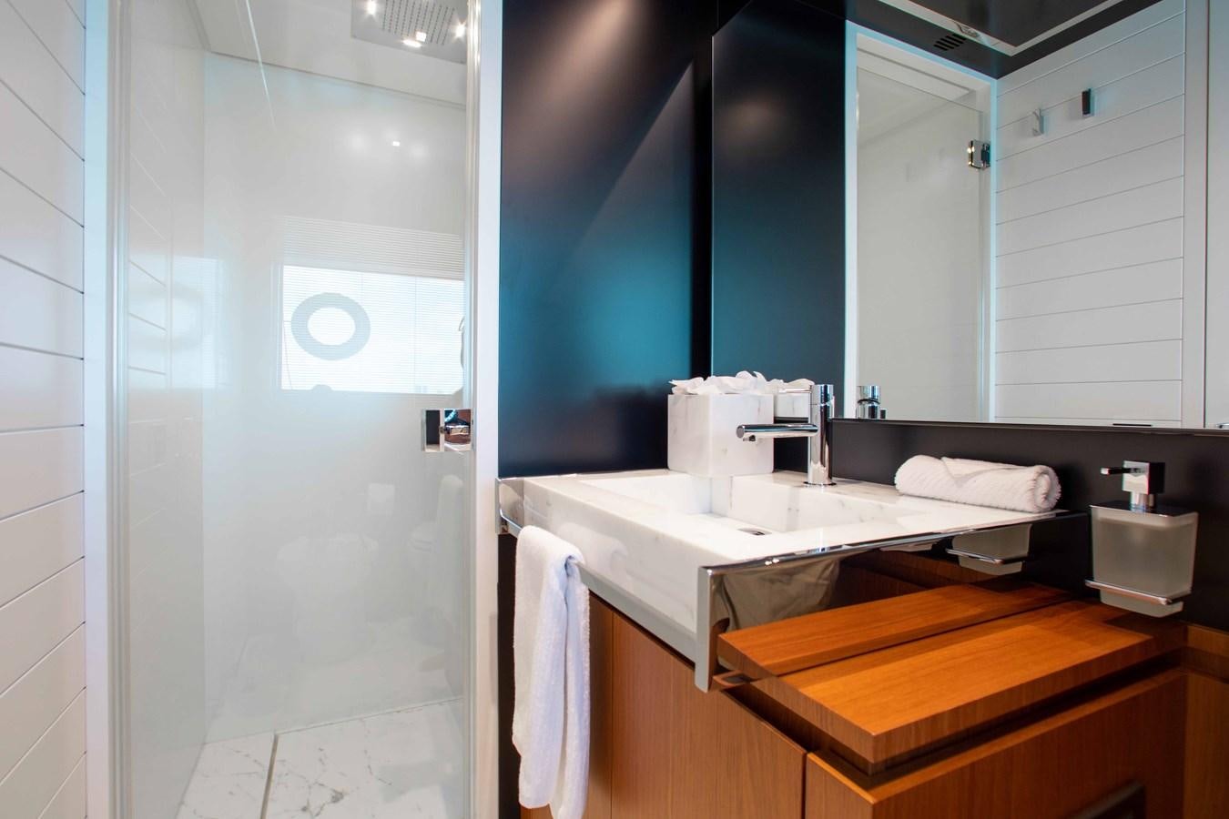 a bathroom with a large mirror aboard KIYOMIZU Yacht for Sale