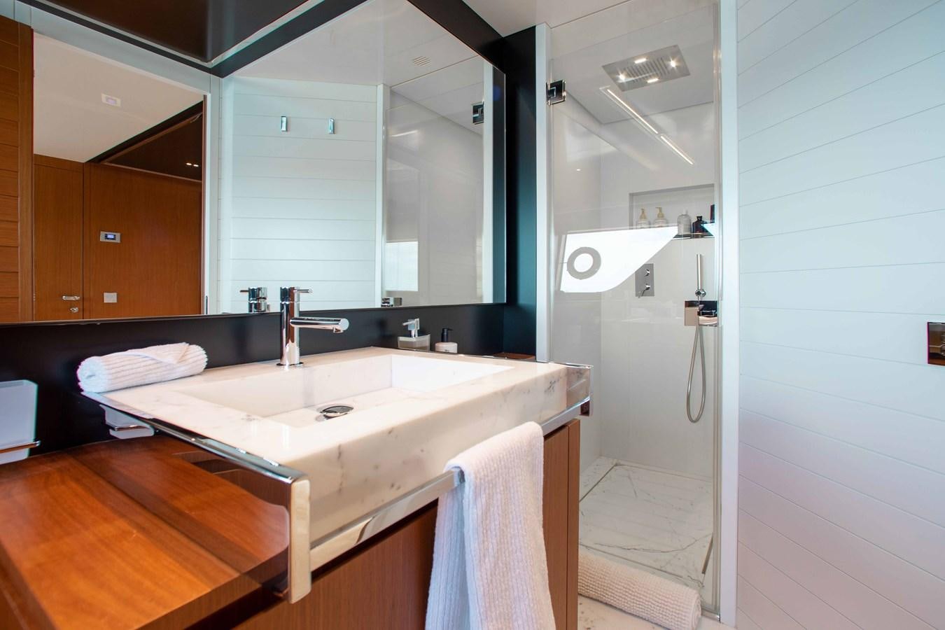 a bathroom with a sink and a mirror aboard KIYOMIZU Yacht for Sale