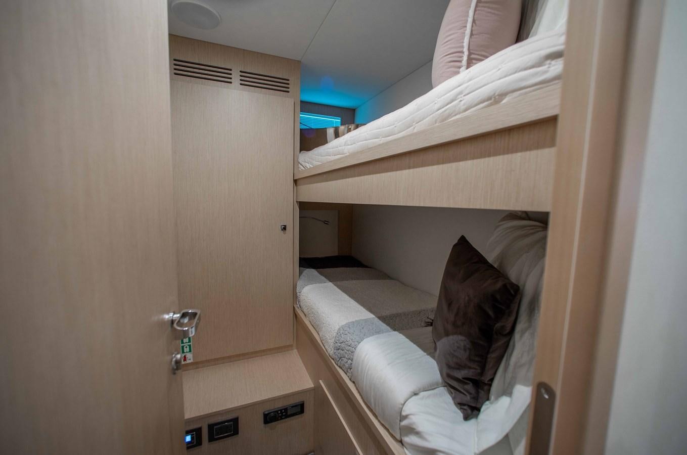 a cat lying on a bed aboard KIYOMIZU Yacht for Sale