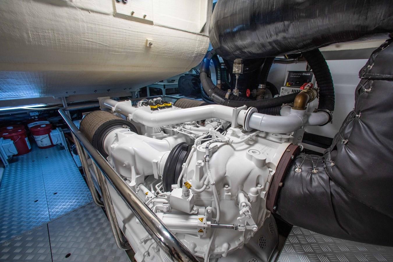 a car engine with a person's leg on the side aboard KIYOMIZU Yacht for Sale
