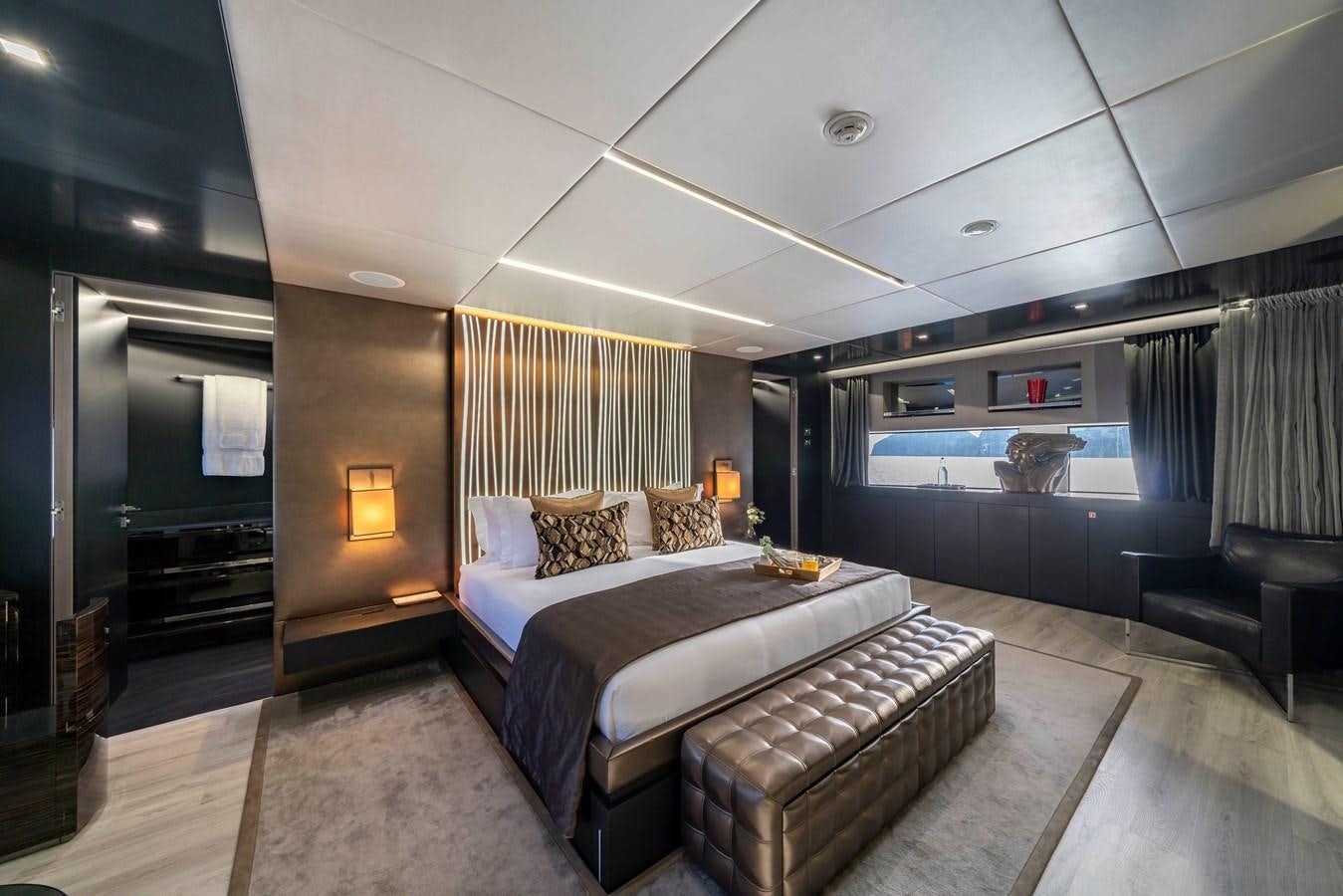 a bedroom with a bed and a tv aboard MAVERICK Yacht for Sale