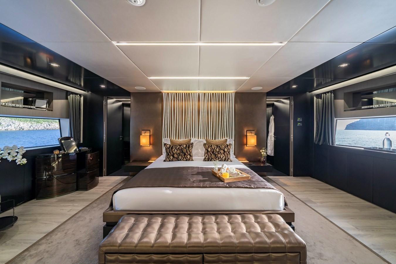 a large modern bedroom with a large bed and a large window aboard MAVERICK Yacht for Sale