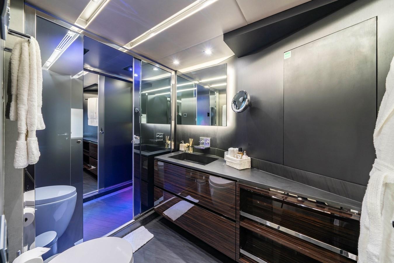 a bathroom with a countertop sink and a large mirror aboard MAVERICK Yacht for Sale
