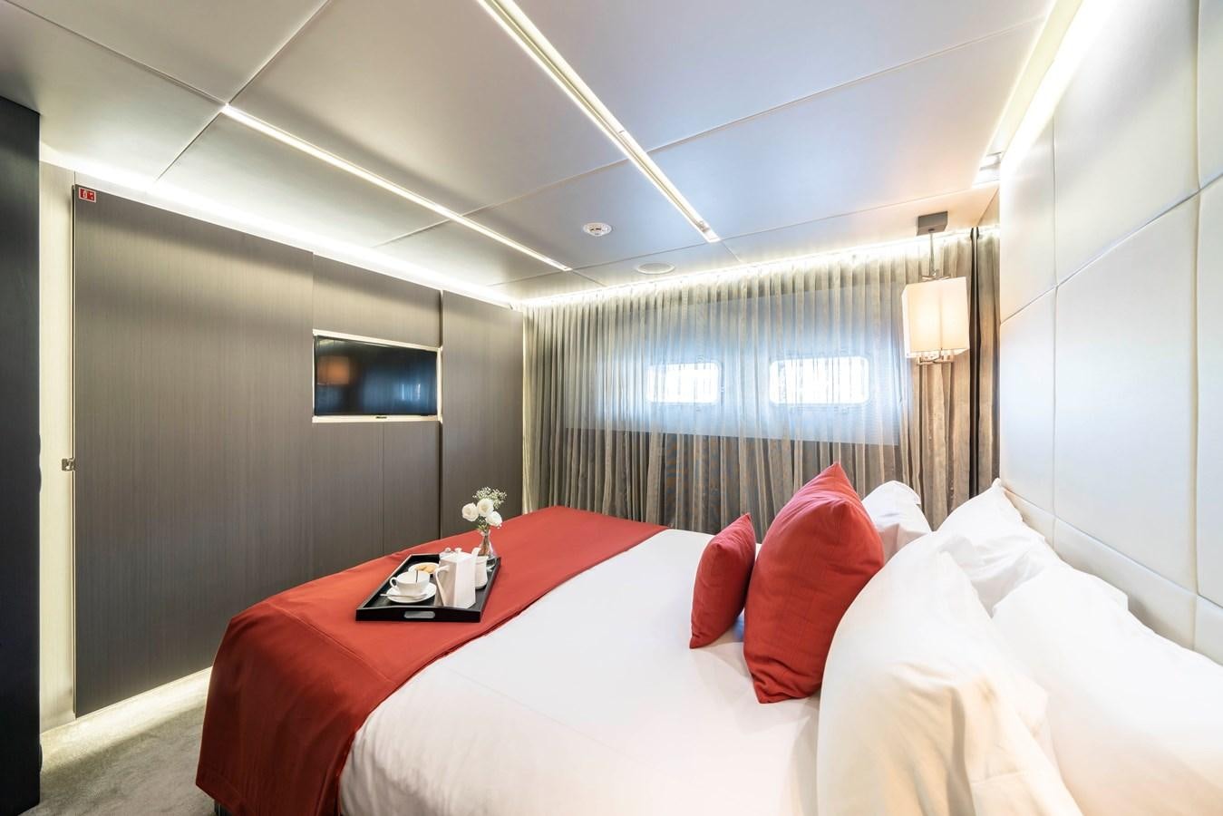 a bed with red pillows aboard MAVERICK Yacht for Sale
