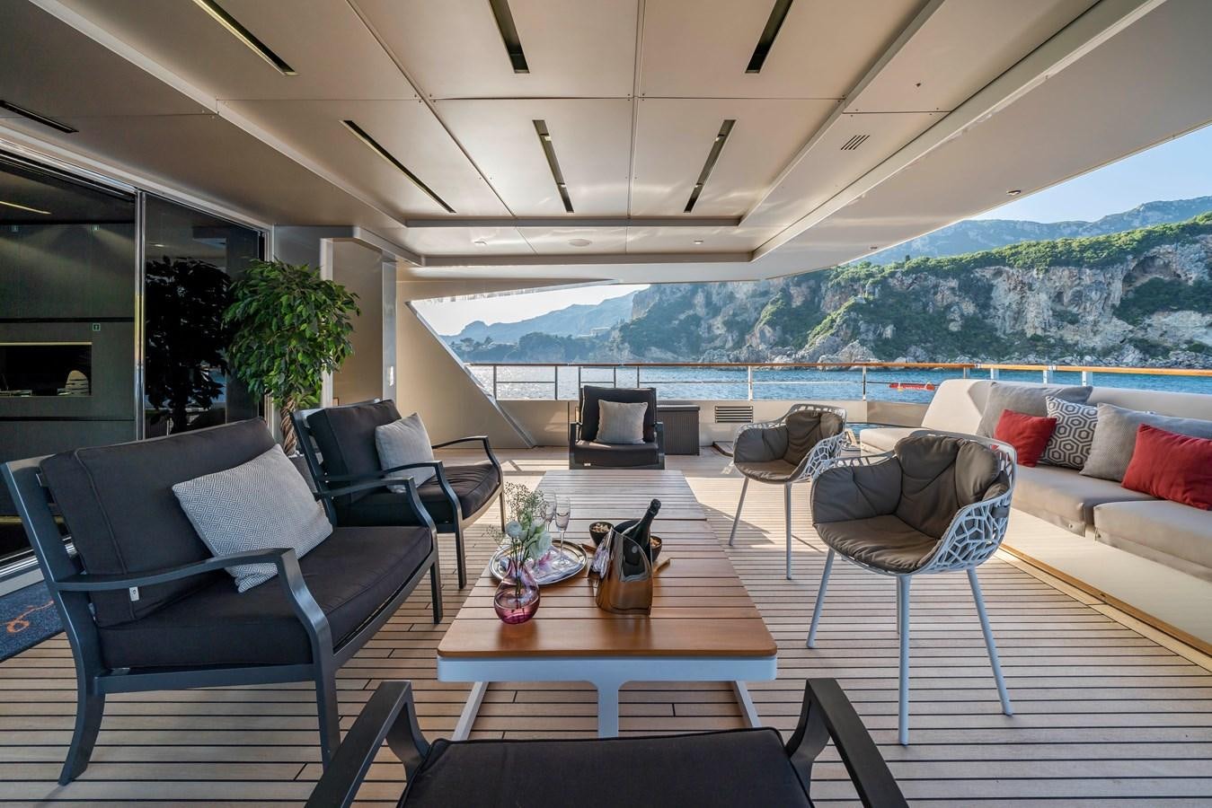 a living room with a table and chairs aboard MAVERICK Yacht for Sale