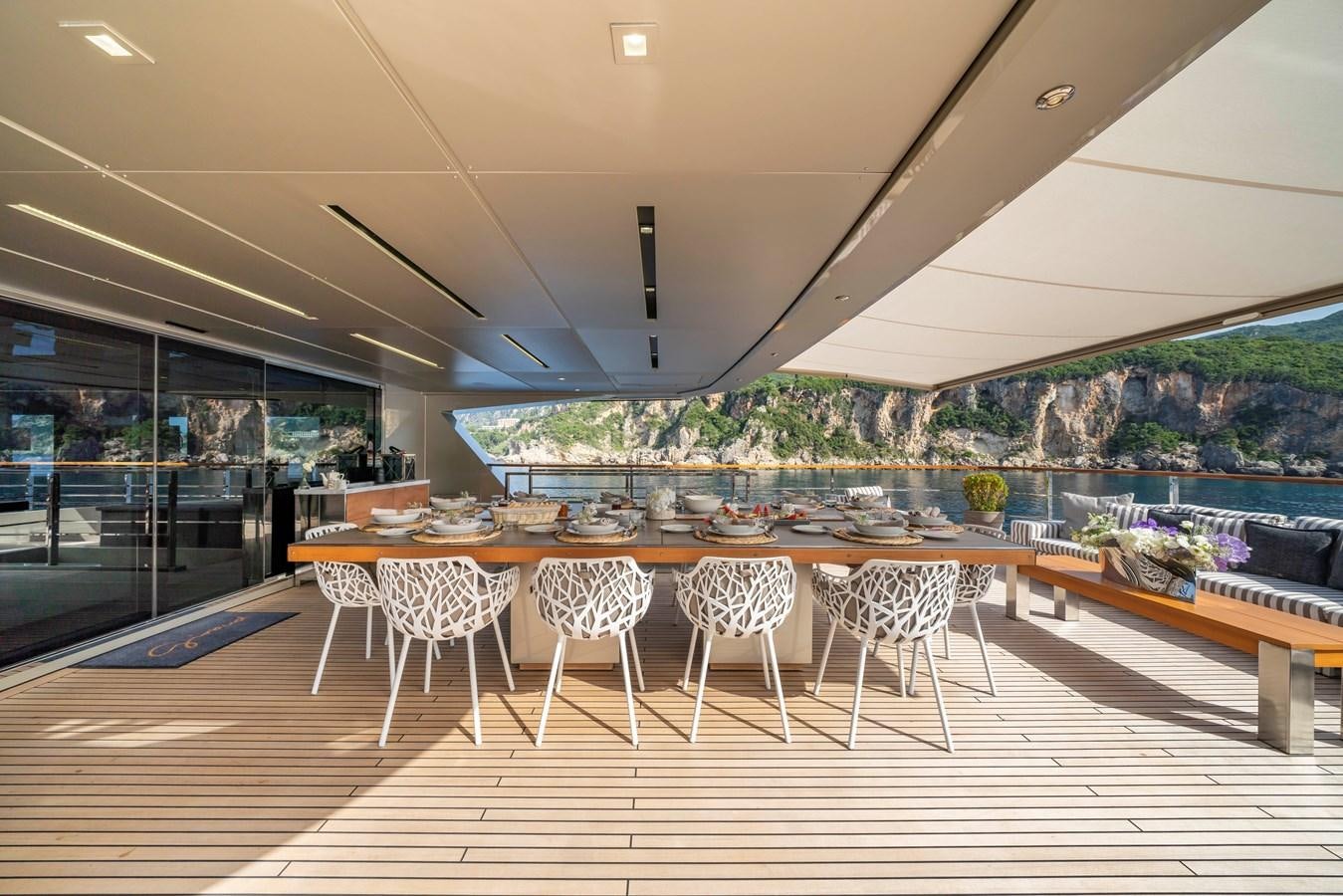 a room with a table and chairs aboard MAVERICK Yacht for Sale