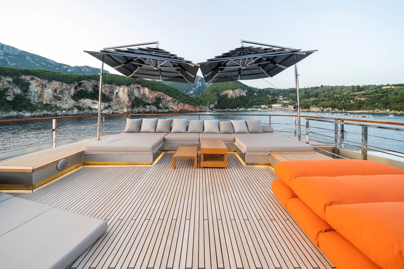 a deck with a large building on it aboard MAVERICK Yacht for Sale