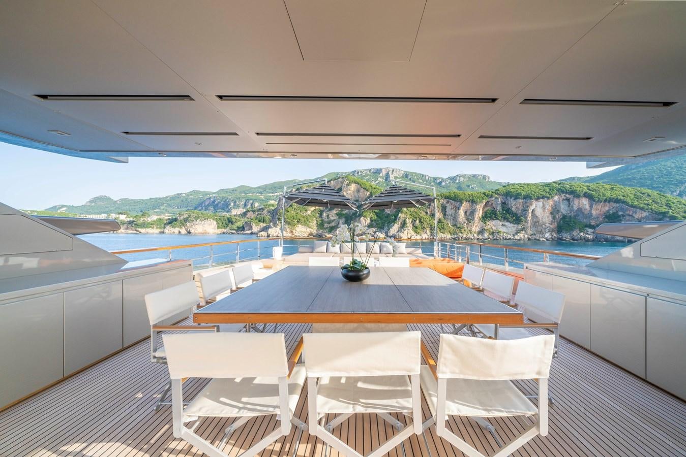 a table and chairs on a deck aboard MAVERICK Yacht for Sale