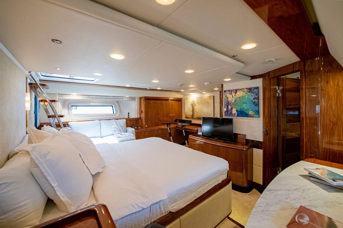 a bedroom with a bed and a television aboard SERAFIM Yacht for Sale