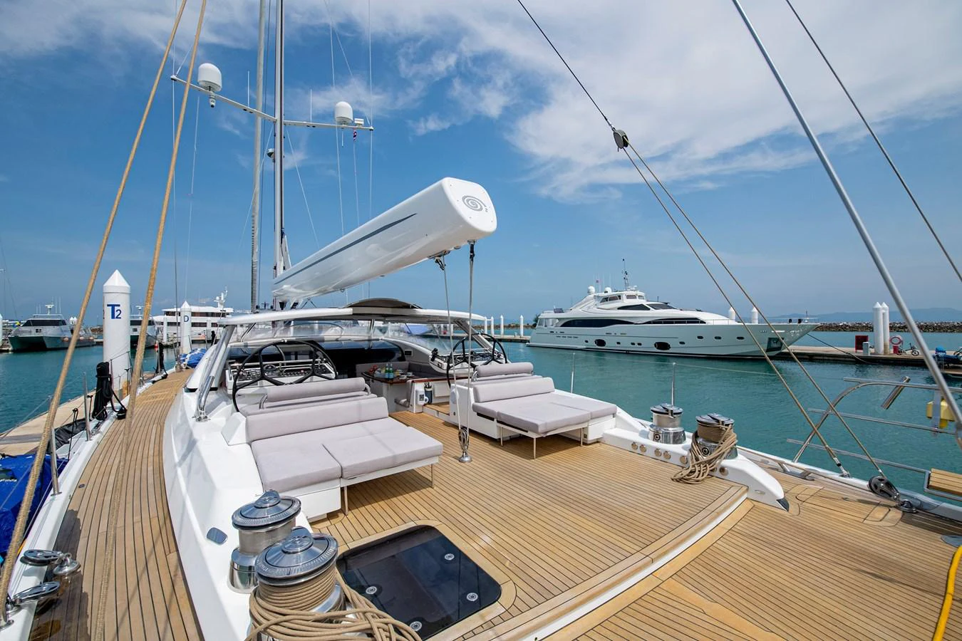 a deck with a boat and a large sailboat aboard SERAFIM Yacht for Sale
