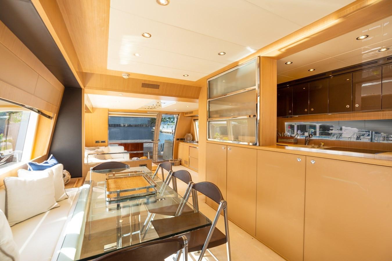 a kitchen with a table and chairs aboard 75' RIVA 2012 Yacht for Sale