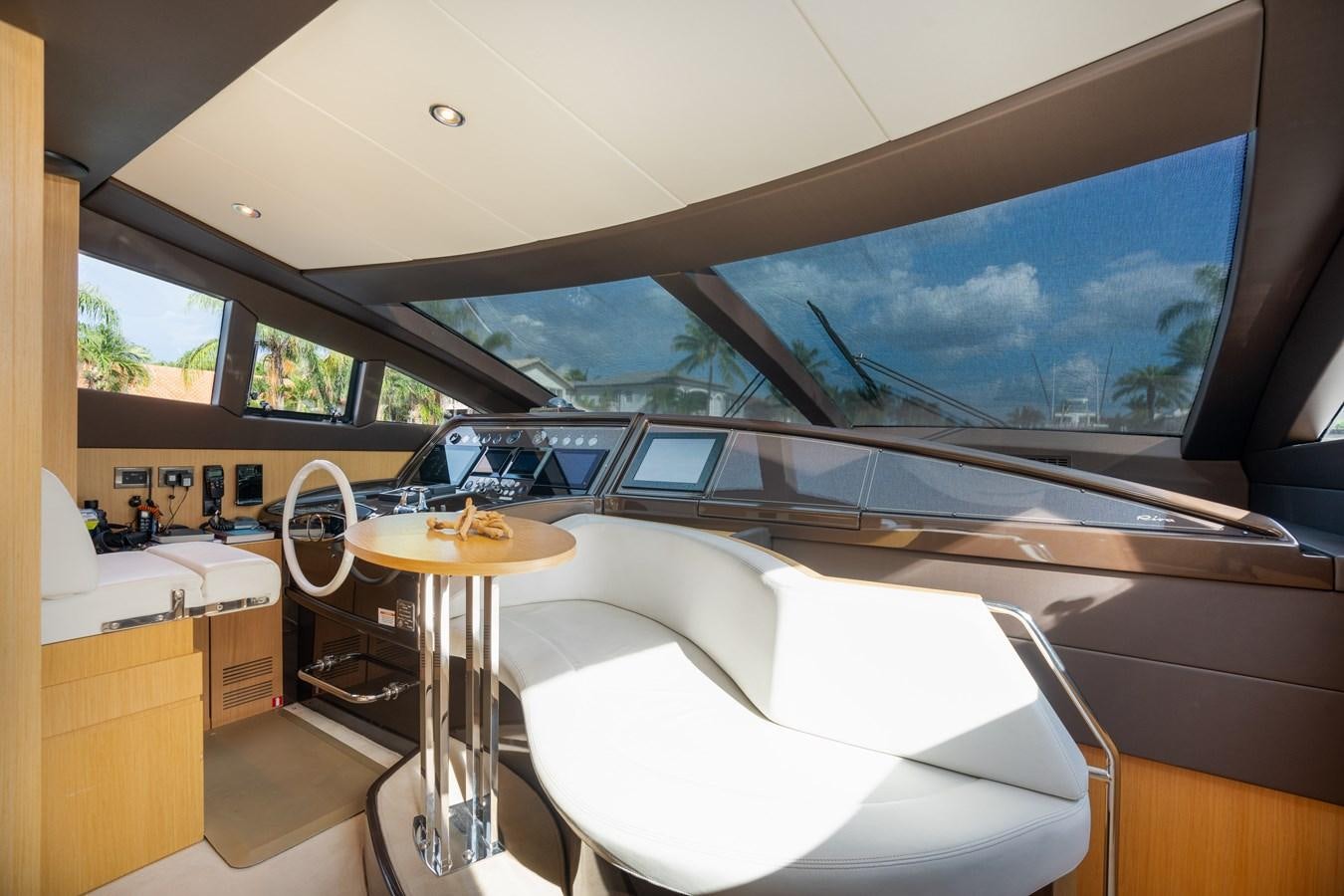 a room with a table and a window with a view of mountains aboard 75' RIVA 2012 Yacht for Sale