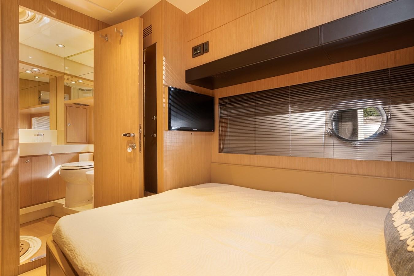 a room with a bed and a television aboard 75' RIVA 2012 Yacht for Sale